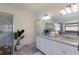 Elegant bathroom with double vanity, a soaking tub, and a glass-enclosed shower at 17418 Blue Ridge Pl, Lakewood Ranch, FL 34211