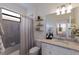 Clean bathroom with granite countertops, modern fixtures, and a tiled shower and decorative shelves at 17418 Blue Ridge Pl, Lakewood Ranch, FL 34211