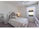 Serene bedroom featuring a plush bed, soft textures, and ample natural light from a window at 17418 Blue Ridge Pl, Lakewood Ranch, FL 34211