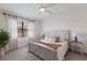 Cozy bedroom with natural light, neutral decor, and a comfortable bed with decorative pillows at 17418 Blue Ridge Pl, Lakewood Ranch, FL 34211
