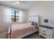 Cozy bedroom features a comfortable bed, soft lighting, and a serene ambiance with a window view at 17418 Blue Ridge Pl, Lakewood Ranch, FL 34211