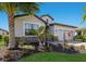 Charming home featuring stone accents, lush landscaping, and a well-manicured lawn on a sunny day at 17418 Blue Ridge Pl, Lakewood Ranch, FL 34211