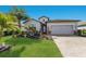 Beautiful single-Gathering home featuring a well-kept lawn, palm trees, and a two-car garage at 17418 Blue Ridge Pl, Lakewood Ranch, FL 34211