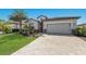 Beautiful single-Gathering home featuring a well-kept lawn and a two-car garage with interlock driveway at 17418 Blue Ridge Pl, Lakewood Ranch, FL 34211