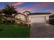 Charming single-Gathering home featuring a lush front yard, stone accents, and a two-car garage at 17418 Blue Ridge Pl, Lakewood Ranch, FL 34211