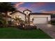 Charming single-Gathering home featuring a lush front yard, stone accents, and a two-car garage at 17418 Blue Ridge Pl, Lakewood Ranch, FL 34211