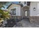 Inviting front porch with stone accents, a sitting bench, and a welcoming entrance door at 17418 Blue Ridge Pl, Lakewood Ranch, FL 34211