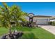 Charming single-story home with well-manicured lawn, palm trees, and a stone-accented facade at 17418 Blue Ridge Pl, Lakewood Ranch, FL 34211