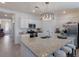 Well-appointed kitchen features a large island with seating, stainless steel appliances, and granite countertops at 17418 Blue Ridge Pl, Lakewood Ranch, FL 34211