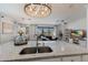 Spacious open-concept kitchen featuring granite countertops and connecting to the dining and living rooms at 17418 Blue Ridge Pl, Lakewood Ranch, FL 34211
