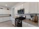 Modern kitchen featuring stainless steel oven and granite countertops. Storage above and below the counter at 17418 Blue Ridge Pl, Lakewood Ranch, FL 34211