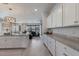 Bright, open kitchen featuring granite countertops, stylish lighting, and seamless flow to the living area at 17418 Blue Ridge Pl, Lakewood Ranch, FL 34211