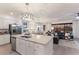 Open-concept kitchen with island, stainless appliances, and views into the dining and living areas at 17418 Blue Ridge Pl, Lakewood Ranch, FL 34211