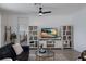 Cozy living room with a modern entertainment center and a glimpse into the serene bedroom at 17418 Blue Ridge Pl, Lakewood Ranch, FL 34211