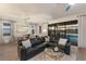 Spacious living room with comfortable seating, modern decor, and a view of the screened-in pool at 17418 Blue Ridge Pl, Lakewood Ranch, FL 34211