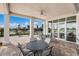 A covered patio with outdoor seating and a grill provides a relaxing area for residents to enjoy a meal at 17418 Blue Ridge Pl, Lakewood Ranch, FL 34211