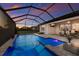 Inviting screened pool with jacuzzi, with views of the outdoor dining space and backyard at 17418 Blue Ridge Pl, Lakewood Ranch, FL 34211