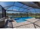 A luxurious pool with a screened enclosure offers privacy and relaxation next to the calming view of a lake at 17418 Blue Ridge Pl, Lakewood Ranch, FL 34211