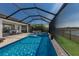 Spacious lanai with a luxurious in-ground pool, spa, and lounging area with a view of the lake at 17418 Blue Ridge Pl, Lakewood Ranch, FL 34211