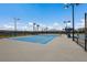 Well-lit tennis court with a pristine surface, perfect for daytime and evening matches for residents at 17418 Blue Ridge Pl, Lakewood Ranch, FL 34211