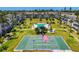 Aerial view of community pool, shuffleboard court, and lush landscaping in a serene setting at 2008 Canal Dr # M3, Bradenton, FL 34207