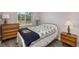 Comfortable bedroom featuring hardwood flooring, a queen bed and side tables at 2008 Canal Dr # M3, Bradenton, FL 34207
