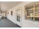 Condo entrance with secure door, nearby mailbox, and large window for natural lighting at 2008 Canal Dr # M3, Bradenton, FL 34207