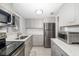 Modern kitchen with stainless steel appliances, granite countertops, and ample cabinet space at 2008 Canal Dr # M3, Bradenton, FL 34207
