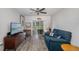 Bright living room with sliding glass doors, ceiling fan, comfortable seating, and wood-look floors at 2008 Canal Dr # M3, Bradenton, FL 34207