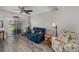 Inviting living room with ceiling fan, comfortable seating, and sliding doors to screened-in porch at 2008 Canal Dr # M3, Bradenton, FL 34207
