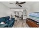 Comfortable living room featuring wood-look flooring, ceiling fan, and lots of natural light at 2008 Canal Dr # M3, Bradenton, FL 34207