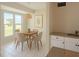 Cozy dining area featuring a modern chandelier, table with four chairs, and a large sunny window at 22343 Lasalle Rd, Port Charlotte, FL 33952