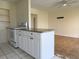 Functional kitchen with white cabinets, tiled floors, and an open layout connecting to the living area at 22343 Lasalle Rd, Port Charlotte, FL 33952