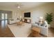 Bright living room with modern furniture, ceiling fan, and neutral color scheme with beautiful tile floors at 22343 Lasalle Rd, Port Charlotte, FL 33952