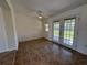 Living room with tile flooring, ceiling fan, and French doors providing access to the backyard at 22343 Lasalle Rd, Port Charlotte, FL 33952