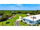 An exterior view of South Venice Yacht Club with kayaks lined up on the lawn at 248 Venice East Blvd, Venice, FL 34293