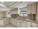 Updated kitchen featuring granite countertops and light wood cabinetry at 248 Venice East Blvd, Venice, FL 34293