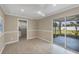 Open living area features light flooring and natural light, with access to the screened patio at 248 Venice East Blvd, Venice, FL 34293