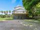 Large backyard featuring a spacious screened-in patio, a balcony and mature palm trees at 3405 10Th W St, Palmetto, FL 34221