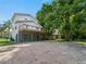 Backyard view with a screened-in patio area, a balcony, and a spacious yard at 3405 10Th W St, Palmetto, FL 34221