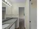 Modern bathroom featuring dual sinks with granite countertops, a mirror, and a walk-in shower at 3405 10Th W St, Palmetto, FL 34221