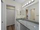Well-lit bathroom featuring a granite vanity, mirror, and ample storage at 3405 10Th W St, Palmetto, FL 34221