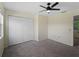 Spacious carpeted bedroom featuring a ceiling fan, large closet, and natural light from the window at 3405 10Th W St, Palmetto, FL 34221