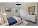 Bright bedroom with a ceiling fan, closet, and a large window showcasing the outdoor view at 3405 10Th W St, Palmetto, FL 34221