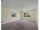 Large bedroom with plush carpet, ceiling fan, and bright windows with exterior views at 3405 10Th W St, Palmetto, FL 34221