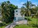 Charming two-story home with an attached garage, lovely yard, and swaying palm trees at 3405 10Th W St, Palmetto, FL 34221