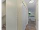 Hallway with wood floors, panel-door closet, and view into the kitchen at 3405 10Th W St, Palmetto, FL 34221