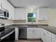 Well-lit kitchen offers stainless appliances, granite countertops and ample cabinet space at 3405 10Th W St, Palmetto, FL 34221