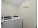 Bright laundry room featuring a white Frigidaire washer and dryer with storage space at 3405 10Th W St, Palmetto, FL 34221