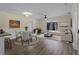 Bright living room is furnished with a dining set, sofa, and a large window at 3405 10Th W St, Palmetto, FL 34221